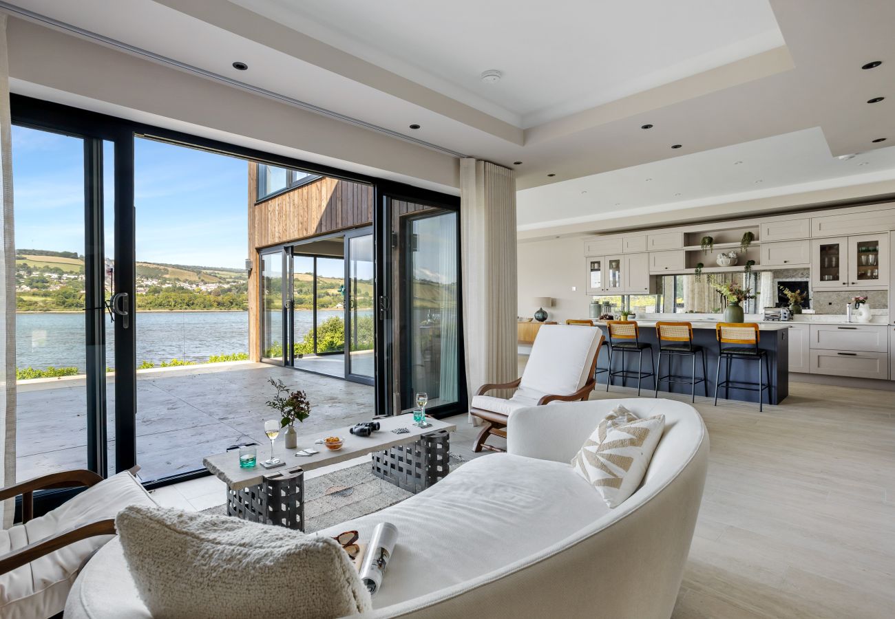 Light-filled living room and kitchen overlooking the river